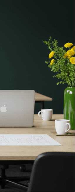 Office desk with laptop and flowers